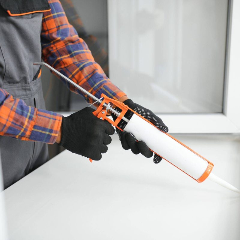 African service man installing window.
